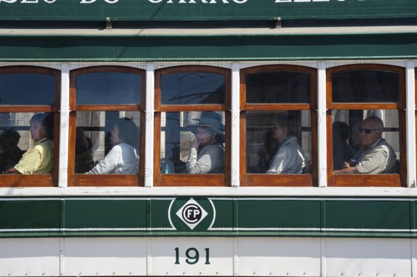 14.06.2018, Porto, Portugal, Europe, Tourists look out of the window during a tram tour through