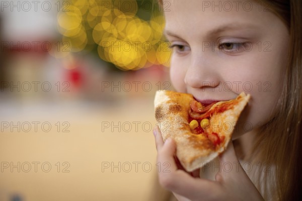 A joyful young child savoring a deliciously tasty slice of pizza, filled with pure happiness in a