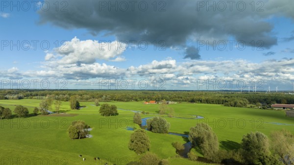 Aerial view of a beautiful green landscape with a small river flowing through. It is in the eastern