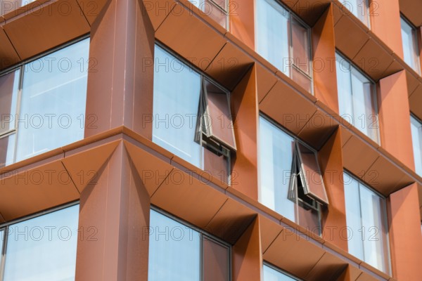 Modern office building exterior with glass facade on clear sky background. Transparent glass wall