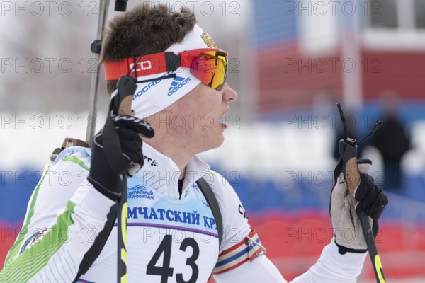 Portrait Russian sportsman biathlete Zlobin Vladislav Khanty-Mansiysk at finish after rifle