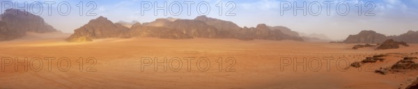 Panorama wide angle of an empty Wadi Rum desert in spring, with some clouds in the air. Travel and