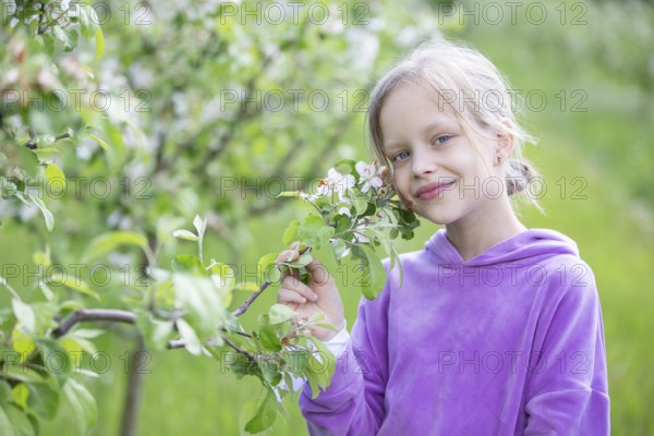 May 27, 2021. Belarus, Gomel, Public event.A beautiful little blonde woman poses in a spring garden