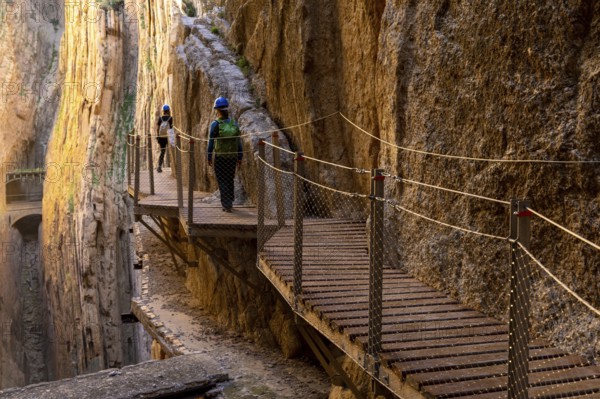 El Chorro, Spain - 22 February, 2022: tourists enjoy hiking the Camino del Rey on a bautiful winter