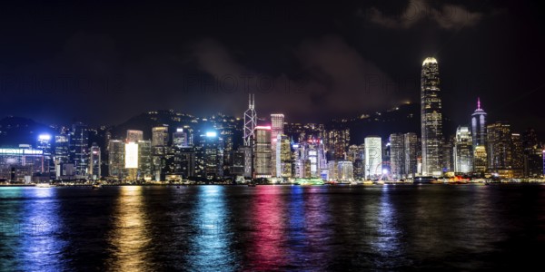 HONG KONG, CHINA - SEPTEMBER 27 2024: Night time view of Hong Kong Island and Victoria Harbour from