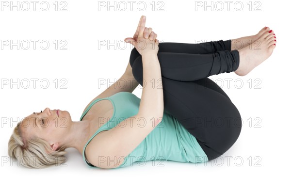 On the back of this young woman in the sport dress covers your knees with your hands with closed