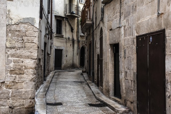 Old ancient typical alleyway in the Italian town of Trani, Southern Italy