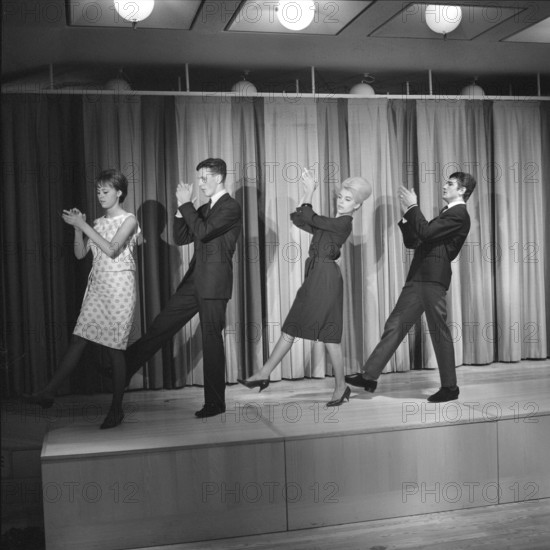 Dancing in the 1960s. The dance Hully Gully is being made popular and here are men and women