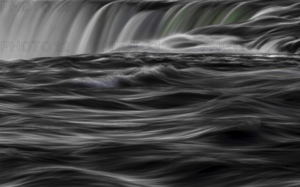 Abstract image of a dynamic, Horseshoe Falls of Niagara Falls in black and white with swirling