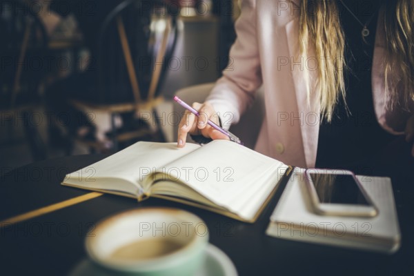 Business, education concept. Woman working in outdoor at coffee shop. Close up caucasian woman hand