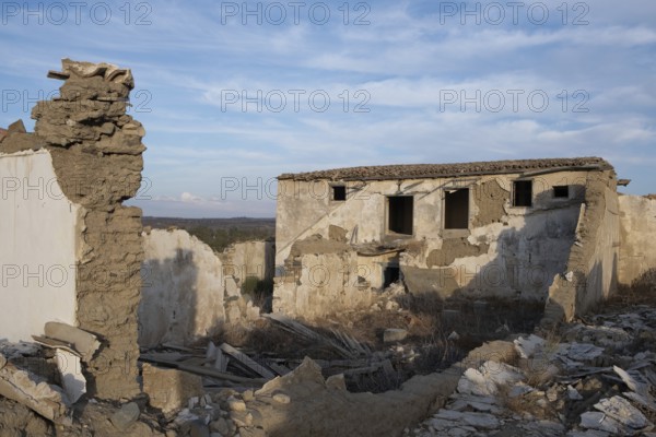 Abandoned and collapsing farm house outdoor. Clay traditional architecture ruins. Deserted places