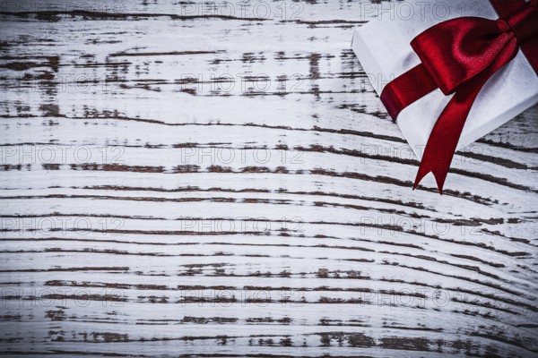 Present box on vintage wooden board copyspace holidays concept