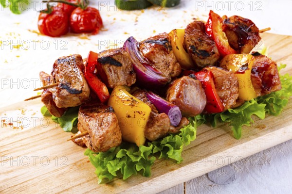 Tasty and colorful meat skewers with peppers and onions