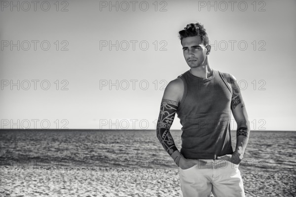 Three Quarter Shot of a Handsome Athletic Young Man in Trendy Attire, on a Beach in a Sunny Summer