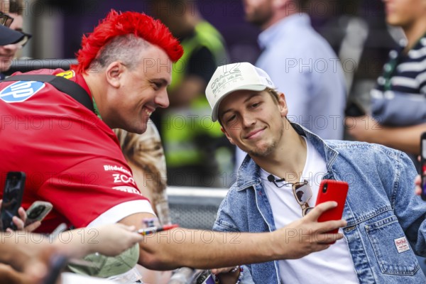 MELBOURNE, AUSTRALIA - MARCH 13: Liam Lawson of New Zealand and Oracle Red Bull Racing with fans