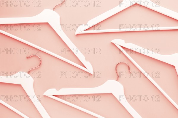 Creative top view flat lay wooden hangers toned living coral color of the year 2019 background copy