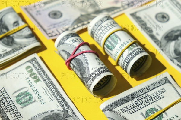 US dollars bundle close up isolated on dollar background. Paper denominations of dollars cash rolls