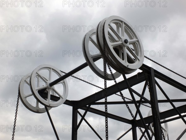 Wheels and pulleys on the historic canal chain bridge in Huddersfield West Yorkshire against grey
