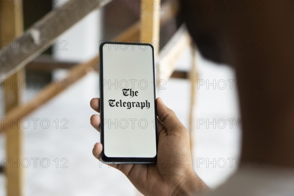 the telegraph logo is displayed on smartphone. The Telegraph is a British daily broadsheet