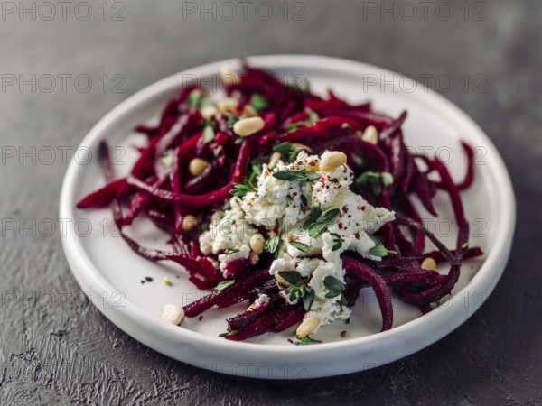 Raw beetroot spaghetti salad with soft cheese, nuts, thyme. Vegetable noodles - Fresh Beetroot