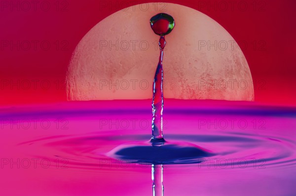 A drop of water rises into the air in front of a large full moon and in a pink-red sky, Planet