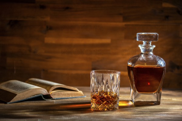 A glass of rum and an old book in a bar in Cuba
