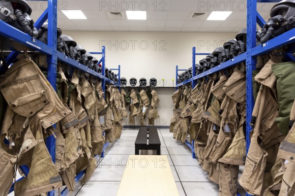 Dressing room of a fighter aircraft (jet fighter) pilot with uniforms and helmets with breathing