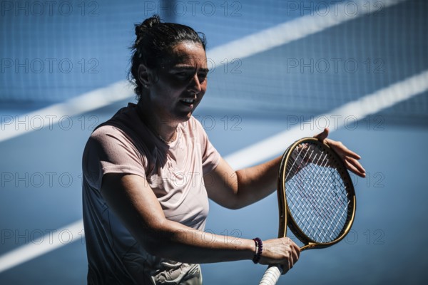 MELBOURNE, AUSTRALIA, JANUARY 12: Ons Jabeur of Tunisia practices with Naomi Osaka of Japan ahead