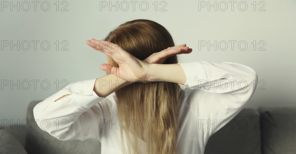 Close-up upset young woman shows stop, no or enough sign with palm of hand, refusal gesture,