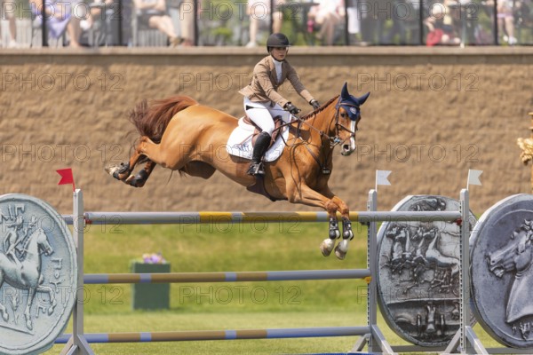 Elena A. Haas, from the United States and riding Claude, compete in the 1.60m Grand Prix during The