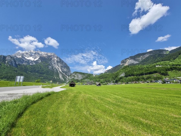 Summer austrian landscape with green meadows and Grimming mountain (2.351 m), an isolated peak in