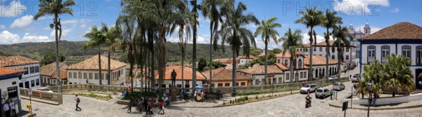 Panorama of traditional houses and palm tree lined street in historic center of Diamantina on a