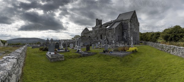 Ballyvaughan, Ireland, 28 July, 2022: panorama view of the historic 13th-century Corcomroe Abbey