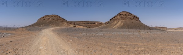 Iconic horseshoe mountain Gara Medouar in the desert near Merzouga, known for different film sets,
