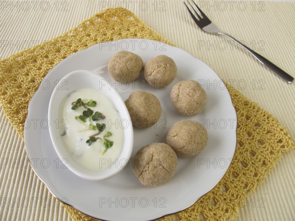 Tsampa balls with yoghurt and radish sprouts