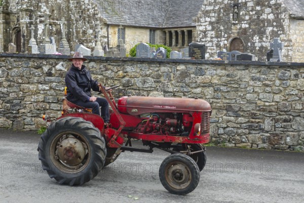 Old tractor Massey Ferguson in front of church and chapel Sainte Nonne, vintage car meeting