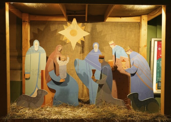 Snowy winter morning and New Year's electrical decorations in the city center, Nativity scene near