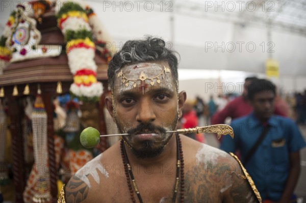 31/01/2018, Singapore, Republic of Singapore, Asia, A devout Hindu man's cheeks are pierced with a