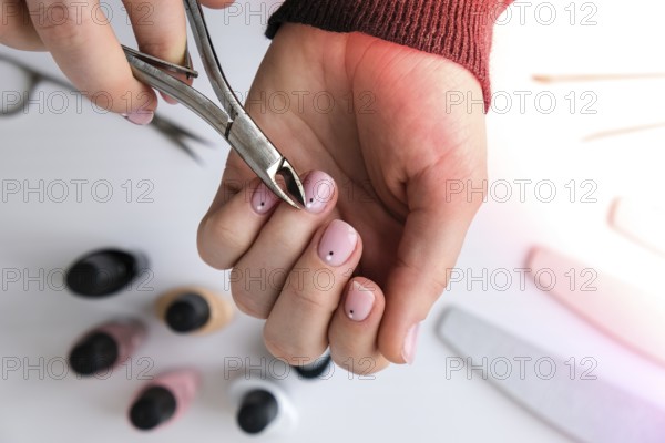 Woman hands, nail polish, manicure tools table top view flat lay. How to do manicure at home