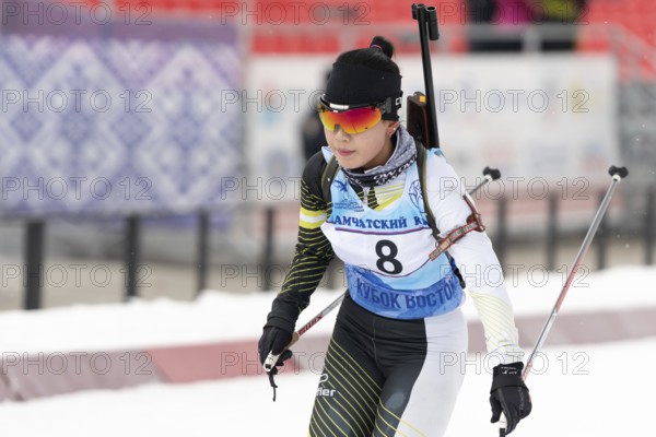 Korean sportswoman biathlete Lee Hyunju South Korea skiing at finish after rifle shooting during