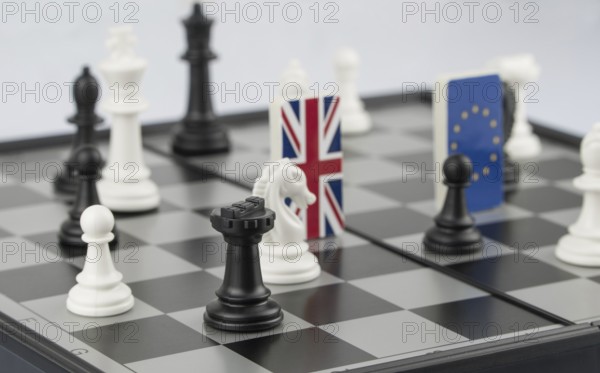 Chess pieces and flags of the European Union and the UK on a chessboard. The concept of the