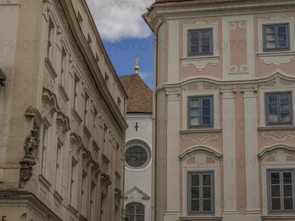 Historic buildings with ornate facades in a narrow alleyway in the historic town centre, Dürnstein,