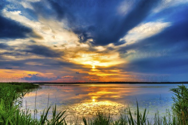 A Beautiful Golden Sunset on The Lake. Amazing Sunset Reflection in The Water