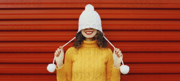 Winter christmas portrait of happy cheerful young woman smiling having fun in yellow sweater, white