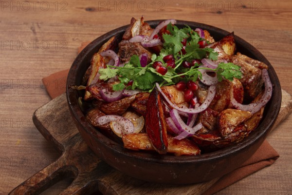 Ojakhuri, a traditional Georgian dish, fried potatoes with meat, in a clay pan, top view, without