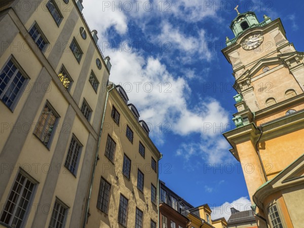 Historic buildings and church tower under blue sky with clouds, stockholm, baltic sea, sweden,