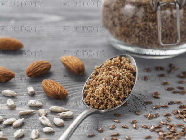 Homemade LSA mix in spoon - Linseed or flax seeds, Sunflower seeds and Almonds. Traditional