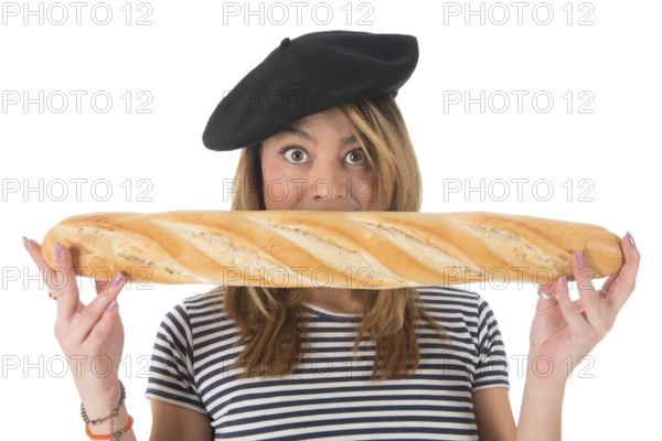 Young French girl with typical French barret and striped shirt eating bread isolated over white