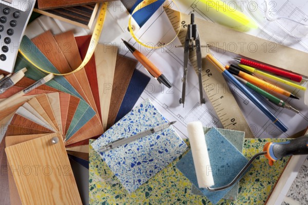 Architect or interior designer workplace desk and design tools with lots of construction material