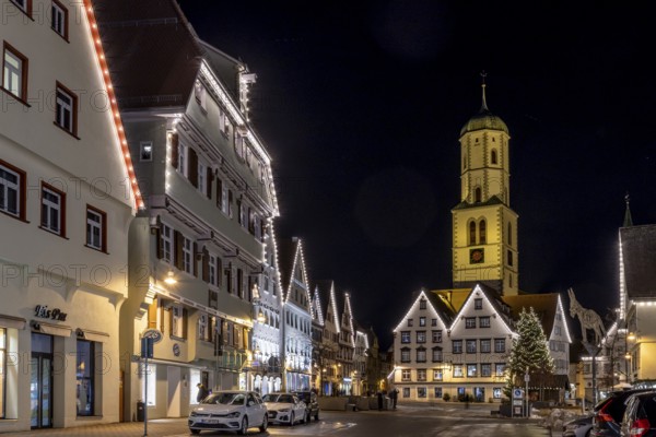 Night photo of historic buildings around the market square with Christmas tree and Christmas lights